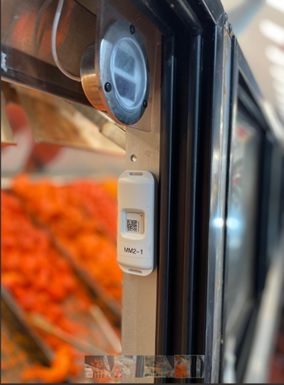 Wireless temperature sensor mounted in a second meat display case